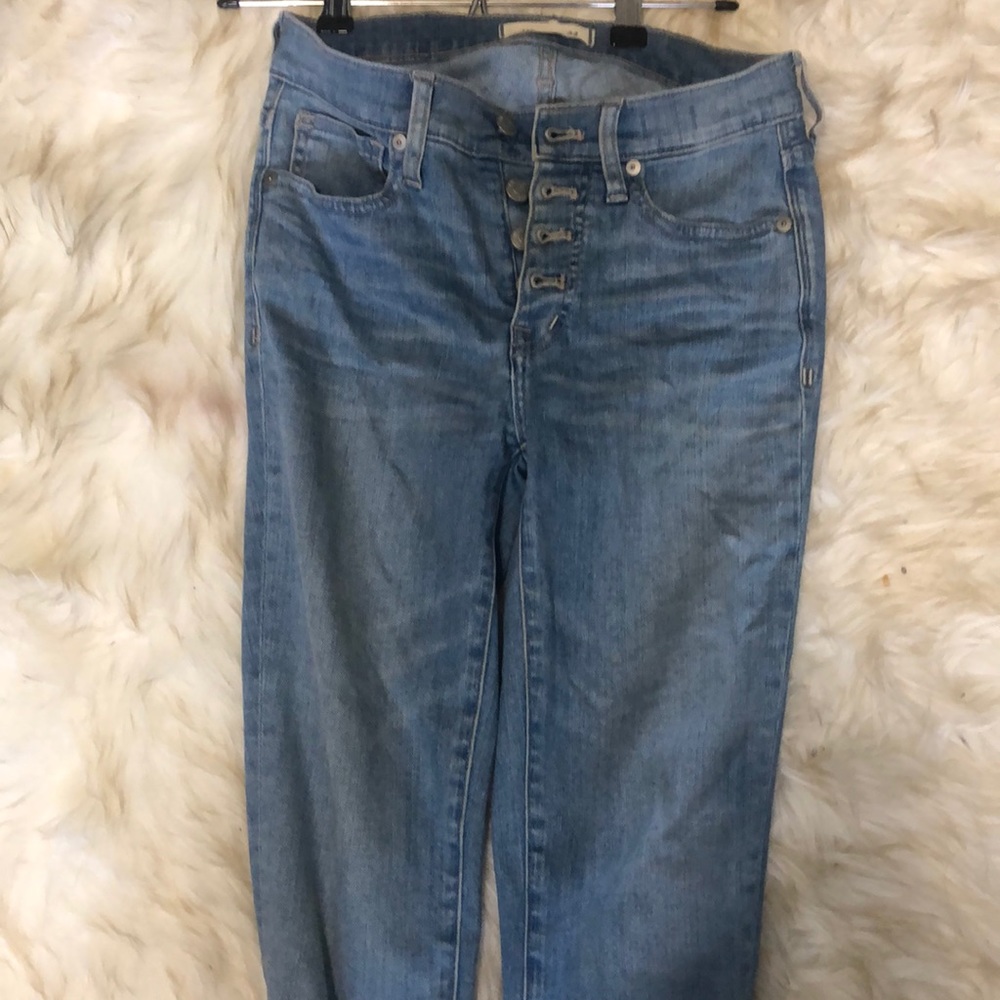 Gently worn button fly distressed denim.